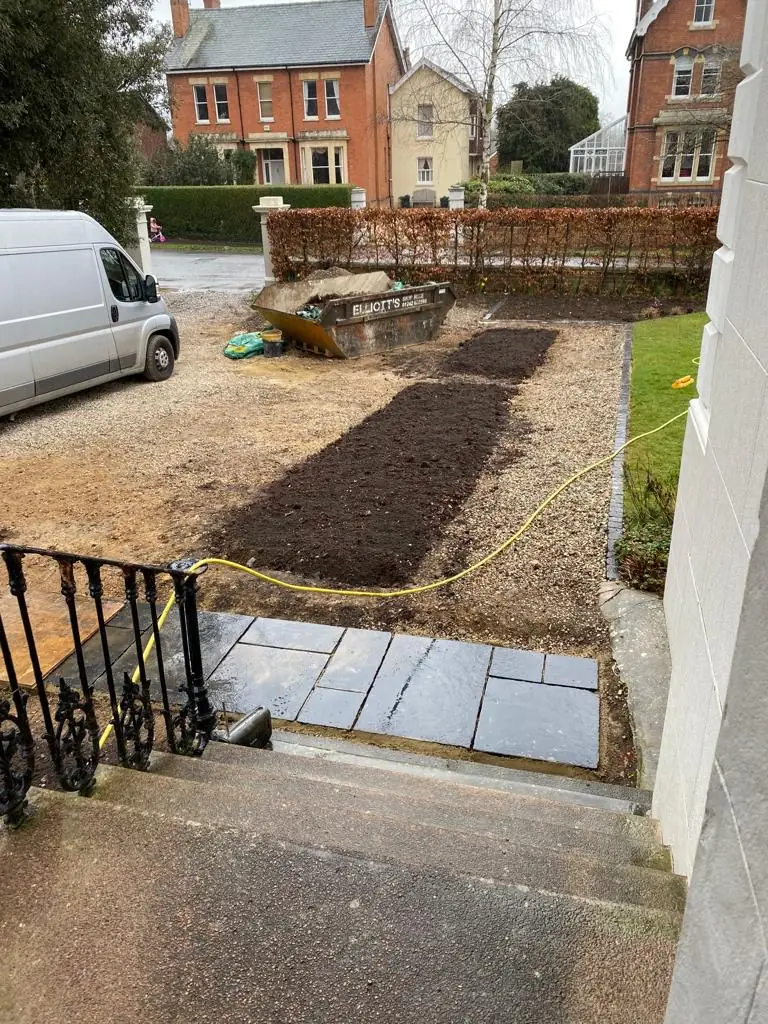 Before: freshly dug beds and slate paving in front of a white townhouse